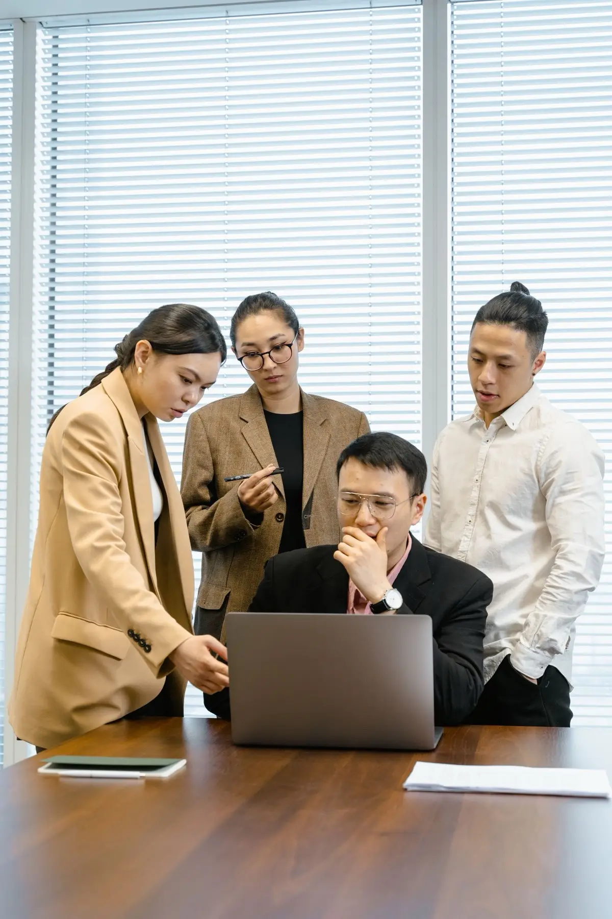A sales team reviewing market data on a laptop